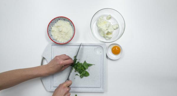 Quitar las hojas a la albahaca, trocearla y mezclarla con la ricota o con el queso crema, el parmesano y la yema de huevo. Sazonar con sal y pimienta.