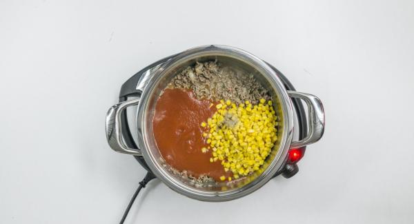 Cuando el Avisador (Audiotherm) emita un pitido al llegar a la ventana de “chuleta”, añadir la carne picada con la mezcla de cebolla y freír. Añadir el maíz y la salsa de tomate, sazonar y mezclar bien.