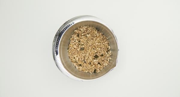 Mezclar el aceite de coco con miel y canela, añadir a la mezcla de muesli y mezclar bien. Cortar un círculo de papel de hornear con la tapa de 24 cm.
