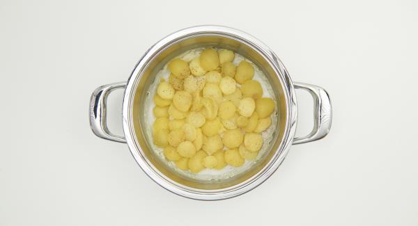 Poner las patatas sobre el papel y sazonar con sal, pimienta y nuez moscada. Agregar las peras, el queso de cabra y el perejil, verter la leche de huevo por encima y cubrir con una capa de masa quebrada.