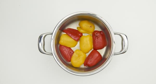 Limpiar los pimientos y cortarlos en cuartos. Colocar el Navigenio en modo de horno (poniéndolo invertido encima de la olla) y ajustar a temperatura alta. Cuando el Navigenio parpadee en rojo/azul, introducir 10 minutos en el Avisador (Audiotherm) y hornear hasta que la piel de los pimientos se vuelva marrón oscuro y empiece a formar burbujas.