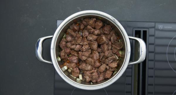 Asar las verduras y las cebollas. Incorporar el tomate concentrado, el vino tinto y la salsa de carne y volver a añadir la carne.